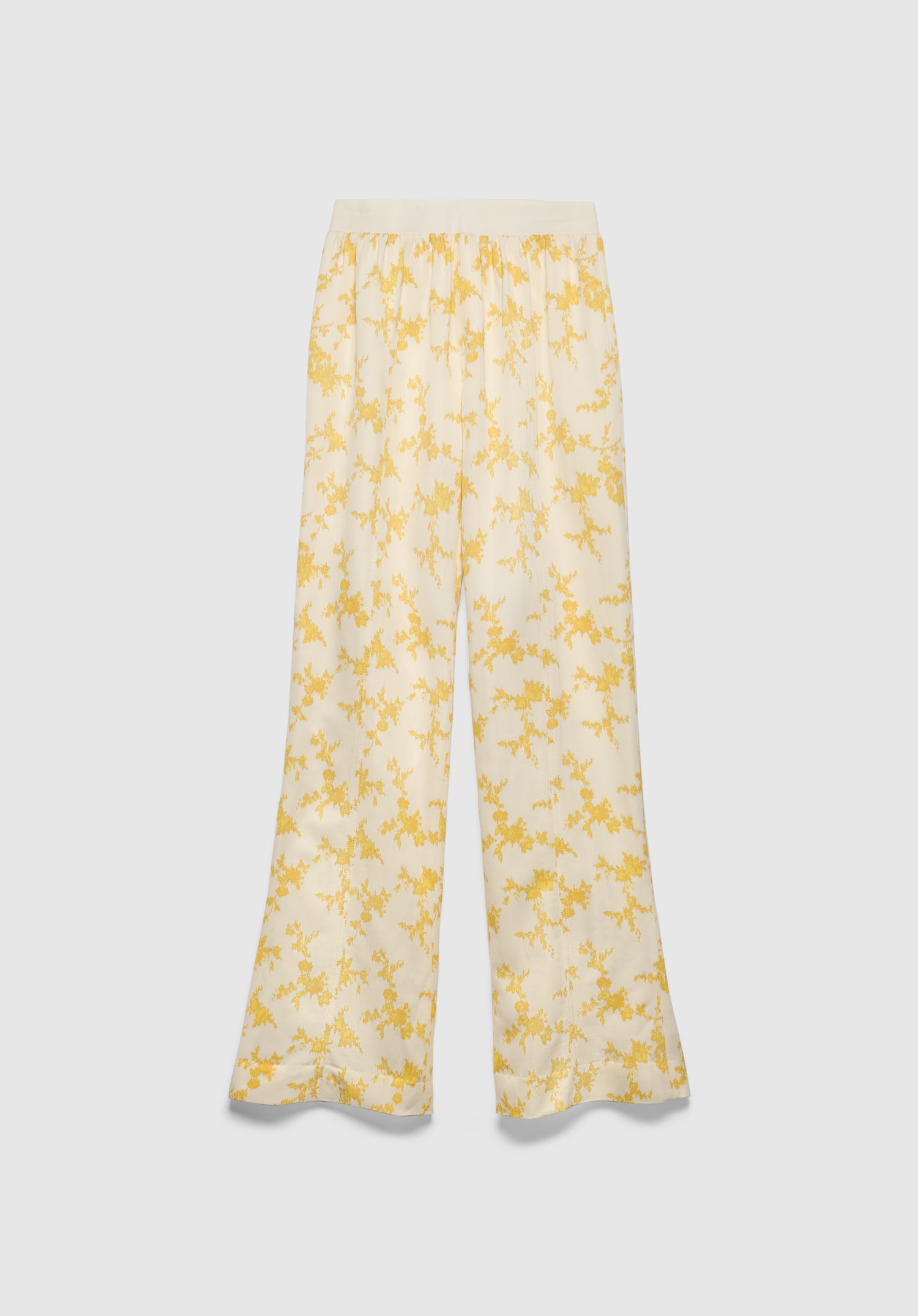 A pair of cream-colored wide-leg pants with a relaxed fit, featuring a soft waistband and a delicate yellow floral print, displayed against a plain background.
