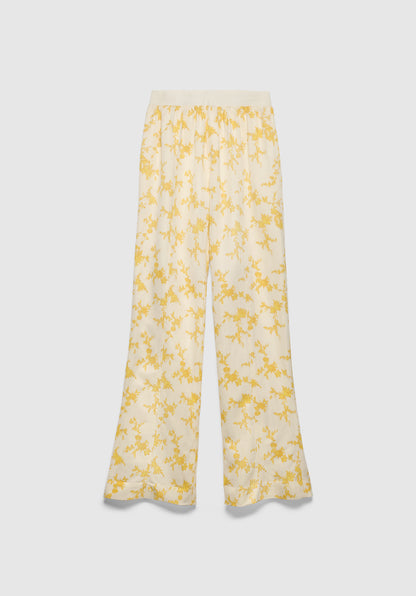 A pair of cream-colored wide-leg pants with a relaxed fit, featuring a soft waistband and a delicate yellow floral print, displayed against a plain background.
