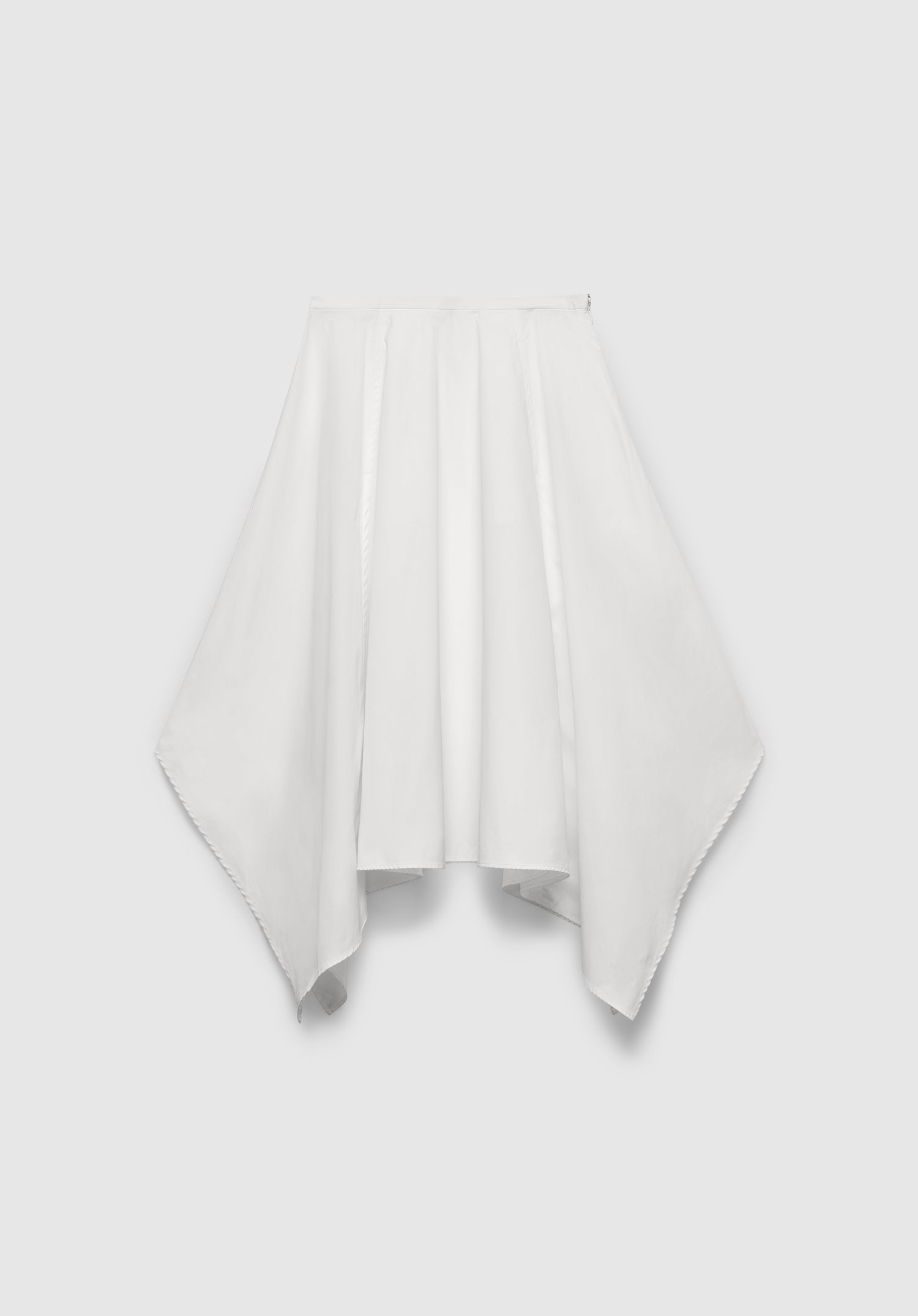 A white skirt with a flowing, asymmetrical hem, featuring a gathered waistband and draped paneling for a soft, sculptural silhouette, displayed against a plain background.
