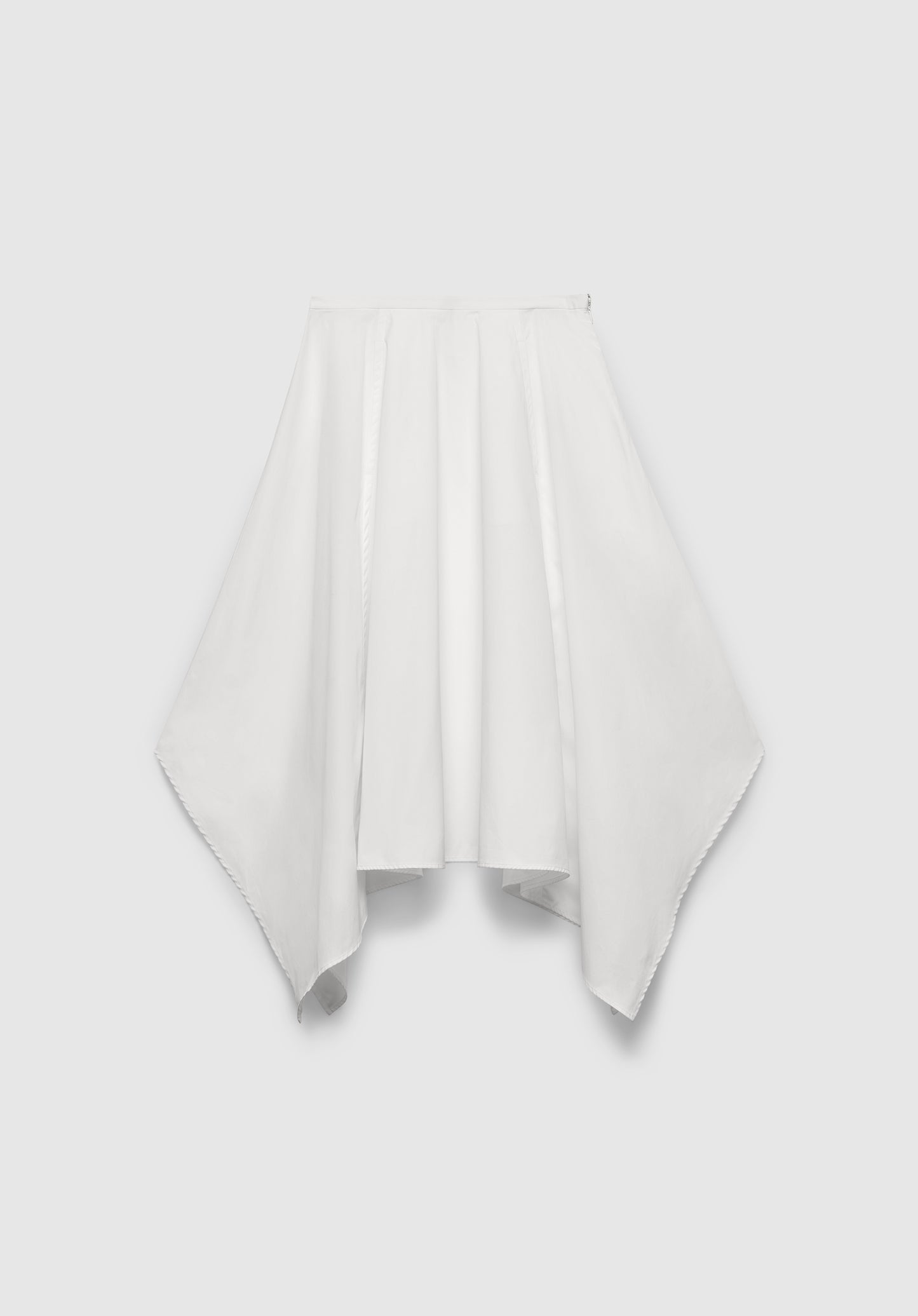 A white skirt with a flowing, asymmetrical hem, featuring a gathered waistband and draped paneling for a soft, sculptural silhouette, displayed against a plain background.
