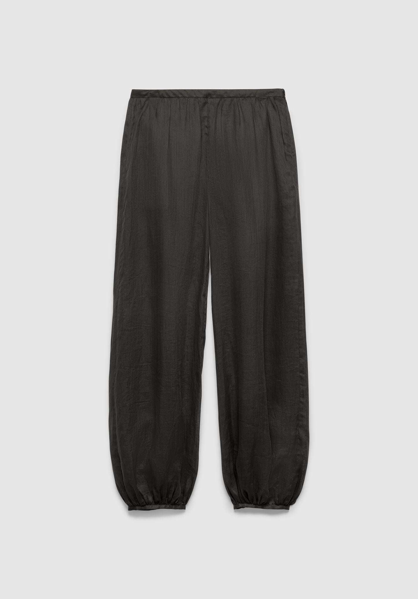 A pair of dark gray relaxed-fit pants with an elastic waistband and gathered cuffs at the ankles, featuring a lightweight, slightly textured fabric, displayed against a plain background.
