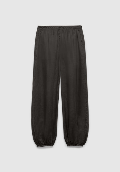 A pair of dark gray relaxed-fit pants with an elastic waistband and gathered cuffs at the ankles, featuring a lightweight, slightly textured fabric, displayed against a plain background.
