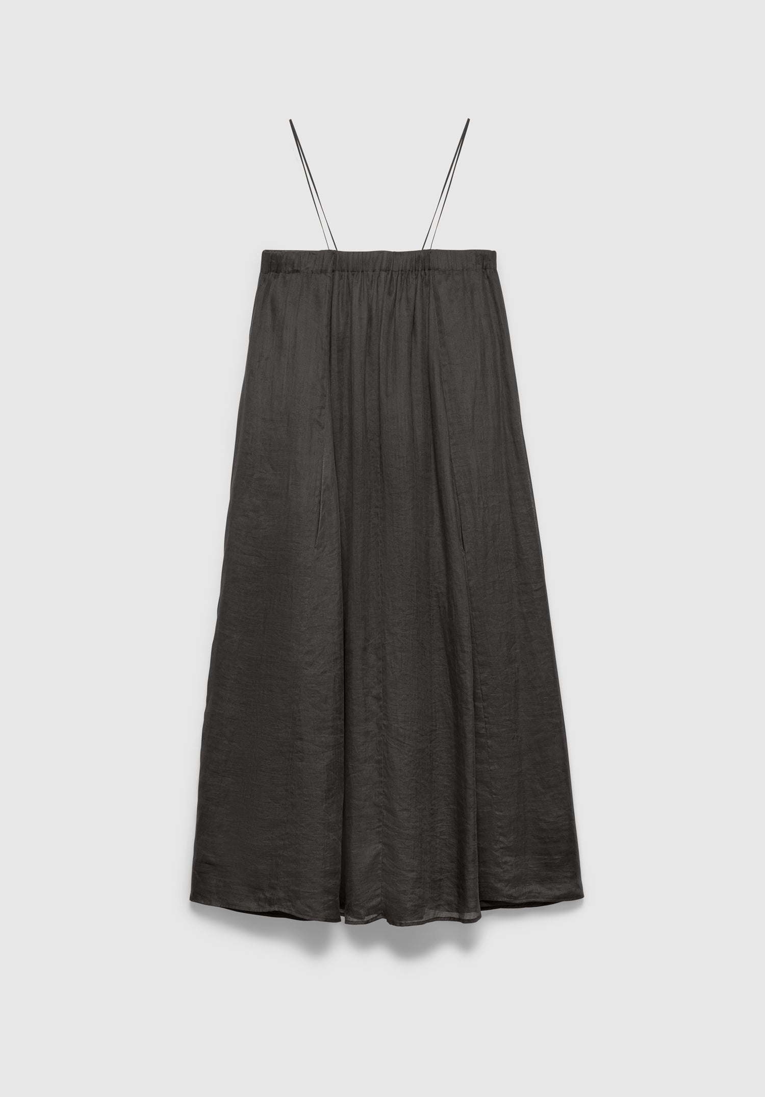 A dark gray midi skirt with a soft, flowy silhouette and a subtle textured finish, featuring thin shoulder straps and a gathered waistband, displayed against a plain background.
