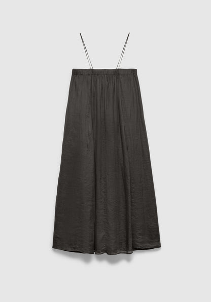A dark gray midi skirt with a soft, flowy silhouette and a subtle textured finish, featuring thin shoulder straps and a gathered waistband, displayed against a plain background.
