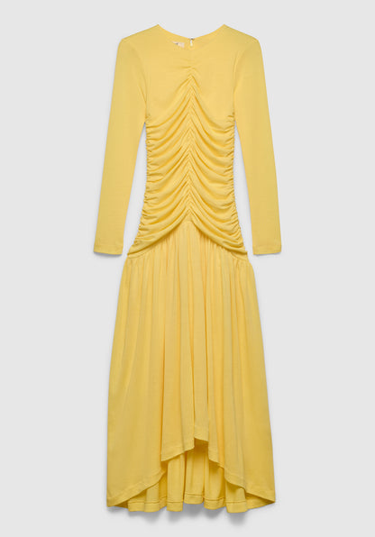 A yellow long-sleeve maxi dress with a fitted bodice, featuring ruched detailing down the front and a flowing, asymmetrical skirt, displayed against a plain background.

