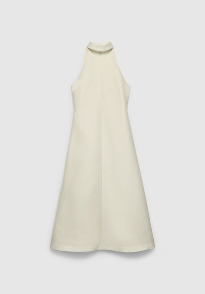 A cream-colored sleeveless midi dress with a high neckline and an A-line silhouette, featuring a clean, minimal design, displayed against a plain background.
