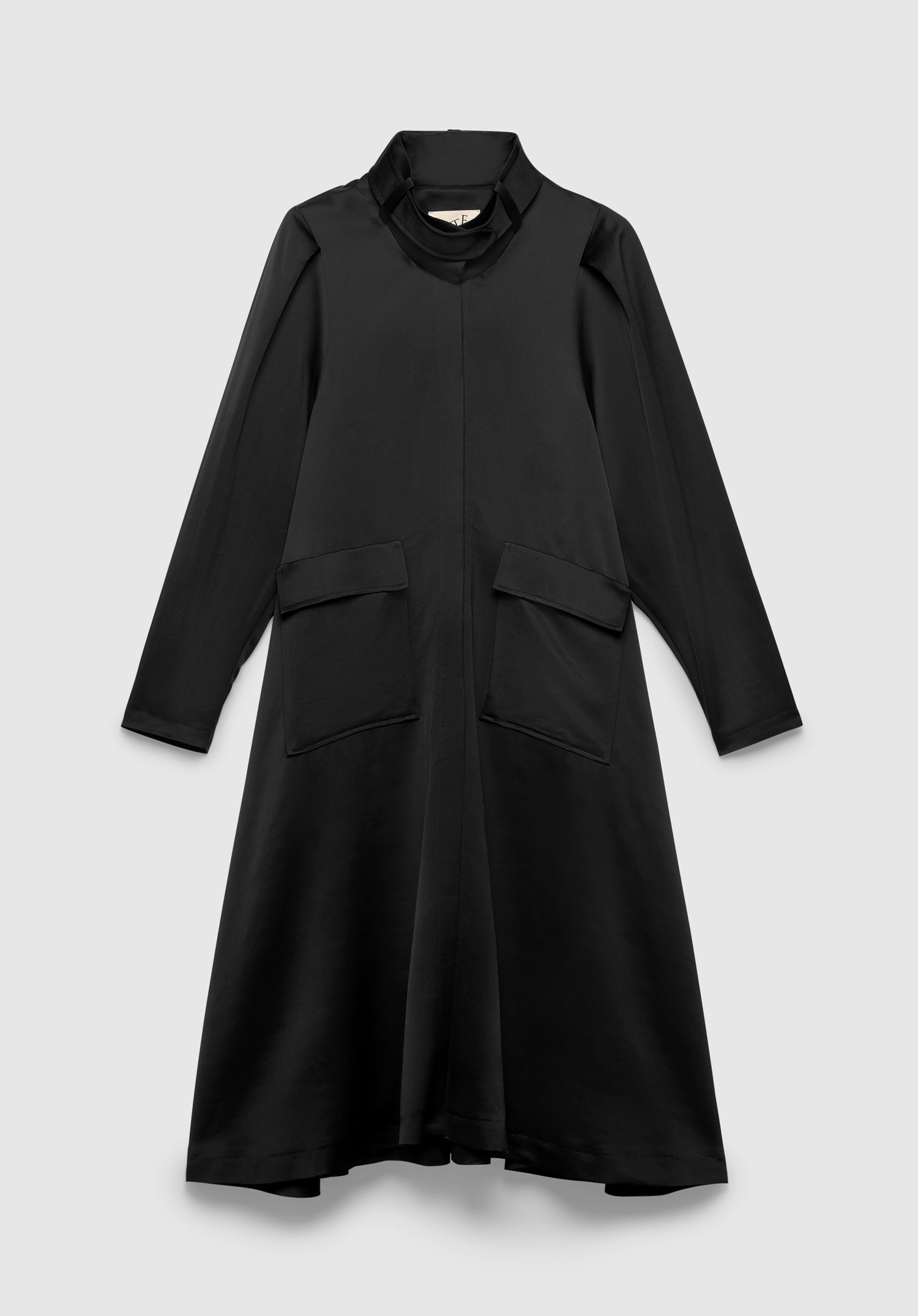 A black long-sleeve midi dress with a relaxed A-line silhouette, featuring a high draped collar, concealed front closure, and large flap pockets, displayed against a plain background.
